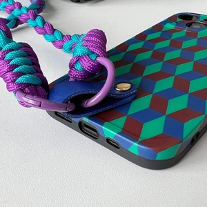 Detailed close-up of woven nylon phone lanyard with purple metal ring and leather patch