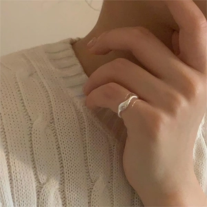 Minimalist S925 sterling silver irregular wave ring with sleek polished finish on hand
