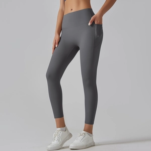 Close-up of high-waisted dark grey yoga pants with side pocket and elastic matte fabric