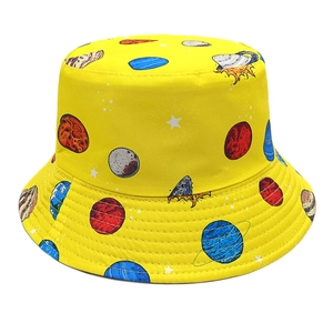 Detailed close-up of yellow bucket hat with cosmic planet prints and sturdy stitching