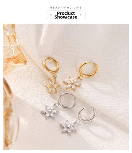 Detailed view of silver and gold sunflower hoop earrings with sparkling cubic zirconia