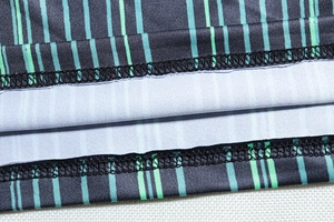 Détail du tissu en maille rayée avec finition d'ourlet à double couture professionnelle