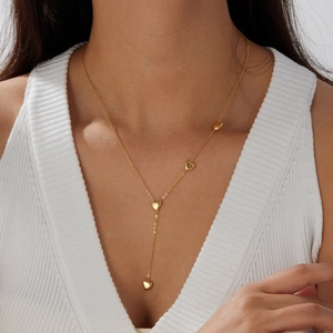 Elegant gold-plated stainless steel Y-shaped necklace with heart pendants on a model