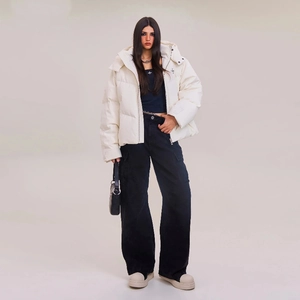 Wide-fit white puffer jacket styled with black cargo pants and platform sneakers