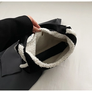 Detail view of large tote bag interior featuring thick white plush lining and PU leather