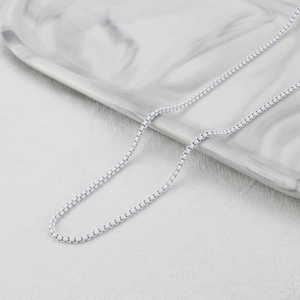 Detailed close-up of a matte white box chain link necklace with minimalist modern texture