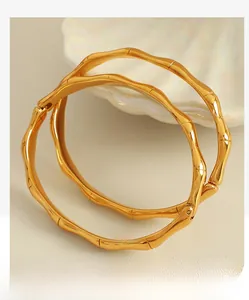 Close-up of gold-plated stainless steel bamboo joint bracelets with a polished finish