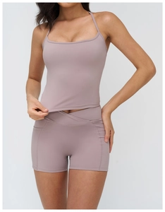 Detail of cross high-waisted shorts and seamless yoga tank top in light purple