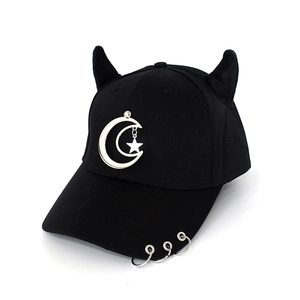 Detail of black baseball cap with 3D devil horns and silver rings on the brim