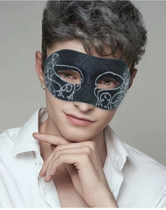 Detail of a black half-face masquerade mask with silver vine patterns for men