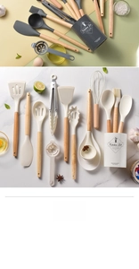 Flat lay of 14-piece silicone cooking utensils with wooden handles and storage bucket