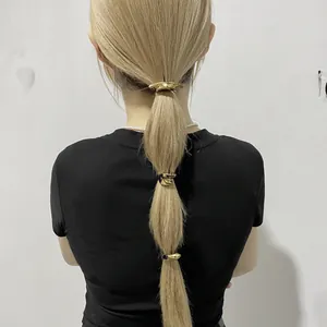 Three-piece gold metal hair cuff set for geometric ponytail styling on model's hair