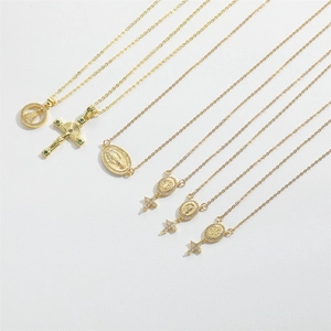 Detail of six vintage gold-plated necklaces with cross and religious saint pendants