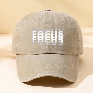 Detailed close-up of FOCUS printed washed cotton baseball cap with vintage finish
