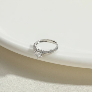 Silver adjustable hollow ring with a large round zircon and side accents on ceramic