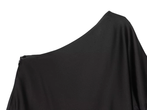 Detail of black asymmetrical neckline and textured fabric on casual women's top