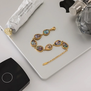 Luxury 18K gold-plated stainless steel bracelet featuring teardrop abalone shell inlays