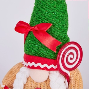 Detailed shot of Christmas gnome plush featuring green knit hat and white braided beard