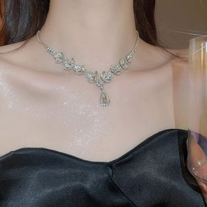 Macro view of crystal wheat ear drop necklace showing pear-shaped stones and fine craftsmanship