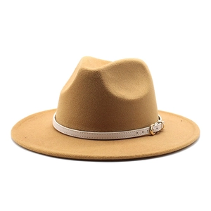 Detail of camel wool fedora hat with white leather band and gold buckle