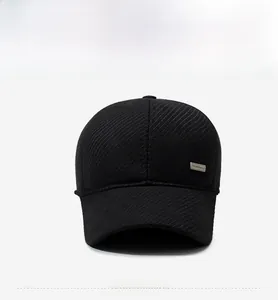 Detail shot of black wool baseball cap featuring textured twill fabric and side metal tag