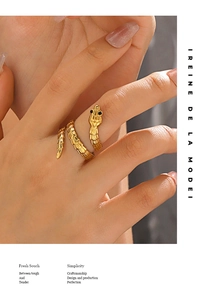 Macro detail of a gold snake ring showing fine scale texture and black stone eyes