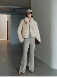 Detail of premium cream faux fur vest showing soft texture and standing collar style