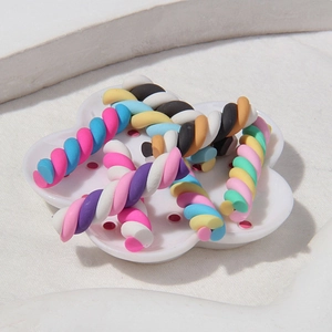 Macro shot of colorful twisted clay sticks on a white plate for DIY phone case crafts