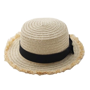 Beige raffia sun hat with black bow and frayed edges for a stylish beach holiday
