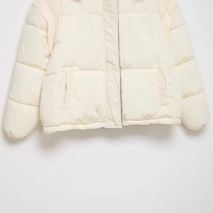Short cream padded puffer jacket with quilted design and side pockets for casual wear