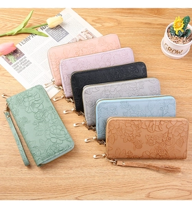 Detailed fan arrangement of long wallets with floral embossing and wristlet straps
