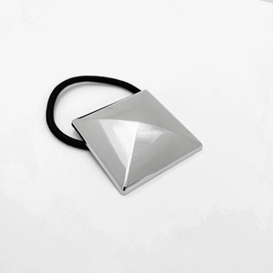 Detail of minimalist black hair tie with silver square pyramid alloy decoration