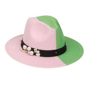 Detail of pink and green fedora hat featuring black band with white pearls and flowers