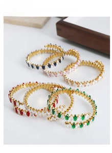 Close-up of gold plated adjustable bracelets with marquise cut multi-color zircons