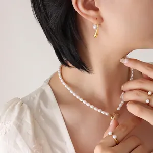 French vintage style pearl jewelry set including gold hook earrings and baroque necklace
