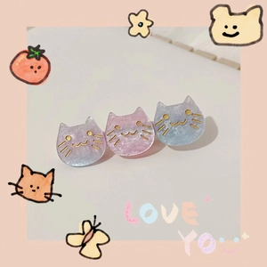 Close-up of three cat-shaped hair clips with purple blue gradient and glitter details