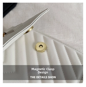 Detail of white quilted leather bag showing the magnetic snap closure and gold hardware