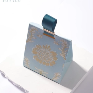 Elegant trapezoid wedding favor gift box in light blue with gold flower pattern