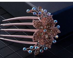 Macro detail of rose gold floral hair comb featuring sparkling champagne rhinestones