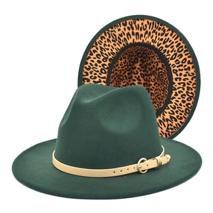 Detail of dark green fedora hat featuring leopard print lining and beige leather buckle strap