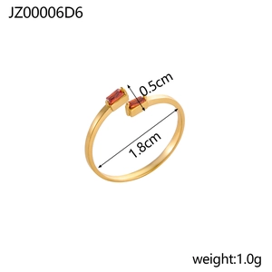 Detail view of gold open ring with rectangle red zircons including size specifications