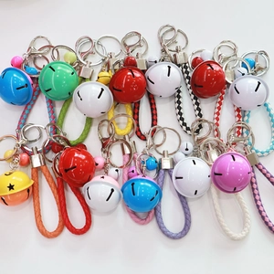 Colorful woven rope keychains with large metal bells in vibrant assorted candy colors