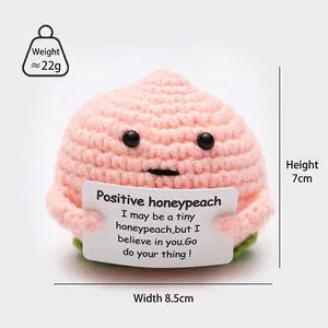 Detail view of a handmade crochet peach doll with dimensions: 7cm height and 8.5cm width