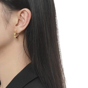 Minimalist S925 sterling silver knotted earrings in gold finish on female model