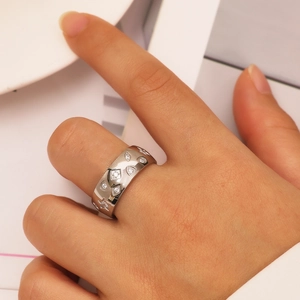Silver wide stainless steel ring with star and eye relief and cubic zirconia stones
