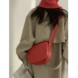Red retro PU leather saddle bag for women shown as a stylish crossbody on a model back