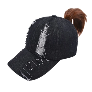 Black distressed denim ponytail baseball cap with criss-cross back and brown hair piece