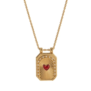 Detail of gold tarot rectangle pendant with red heart gemstone and sunray engraving