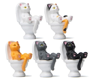 Detailed view of five cute resin miniature cats sitting on white toilets for desktop decor