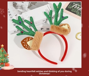 Detail of Christmas reindeer antler headband with green sequins, bells and brown fur